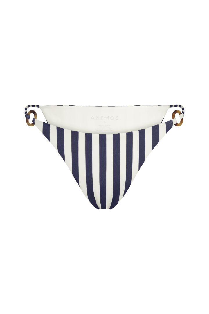 Tortoise Ring String Tie Bikini Bottom in marine vertical stripes with adjustable side ties, tortoise ring accents, and a high-cut, vintage-inspired silhouette.