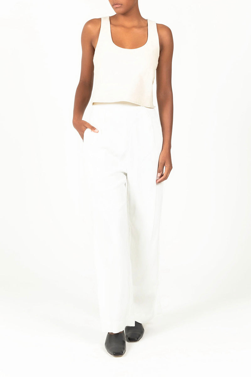 Ecomm Model wearing the Wide Leg Pant in Stretch Twill White featuring a naturally elegant drape and a subtle single front pleat for a relaxed yet polished menswear-inspired look.
