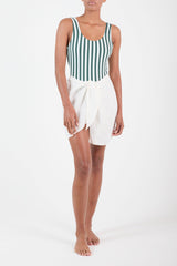 Ecomm Model wearing Wrap Mini Skirt Cover Up in Linen Cupro Blend White, with the comfort and simplicity of linen and a unique self-tie.