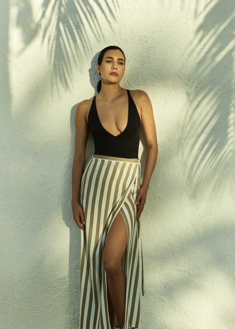 Model wearing the Wrap Tie Maxi Skirt Natural Stripe in Striped Stretch Twill, designed to layer lightly over swim or pair back with refined separates.