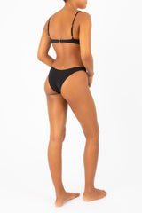 Eighties High-Cut Black Bikini Bottom on Ecomm Model, designed with a figure-flattering high-cut leg in a range of seasonal and classic shades. 